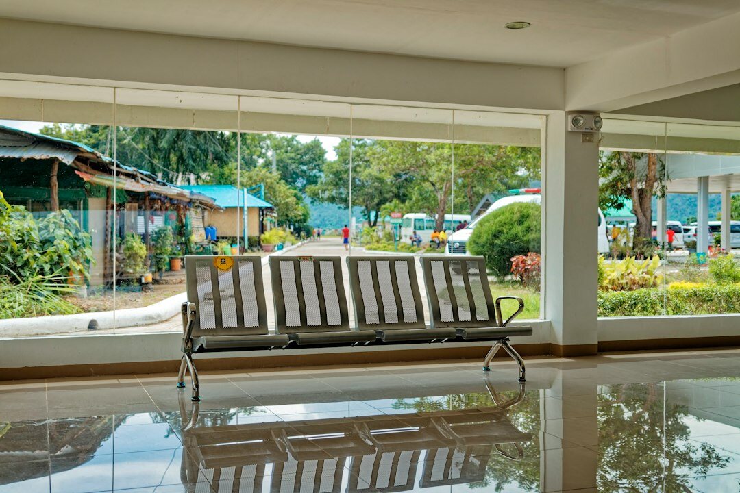 Bright reception and waiting area of a research institute with seating and plants
